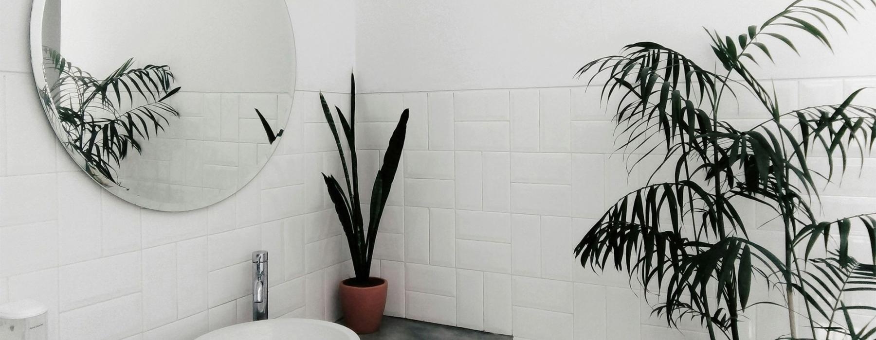 a bathroom with a round mirror
