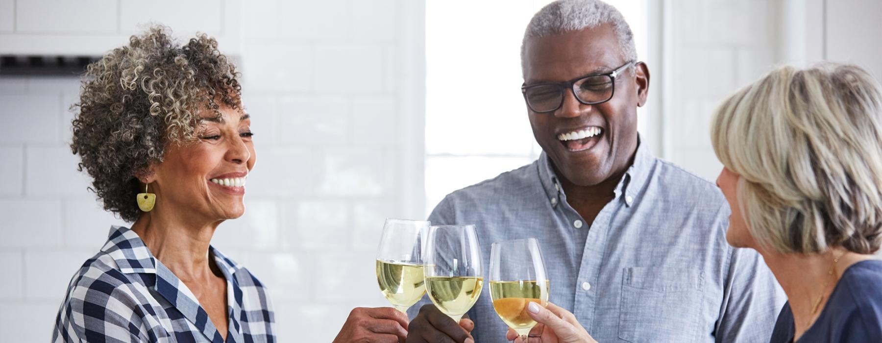 a few people toasting wine glasses