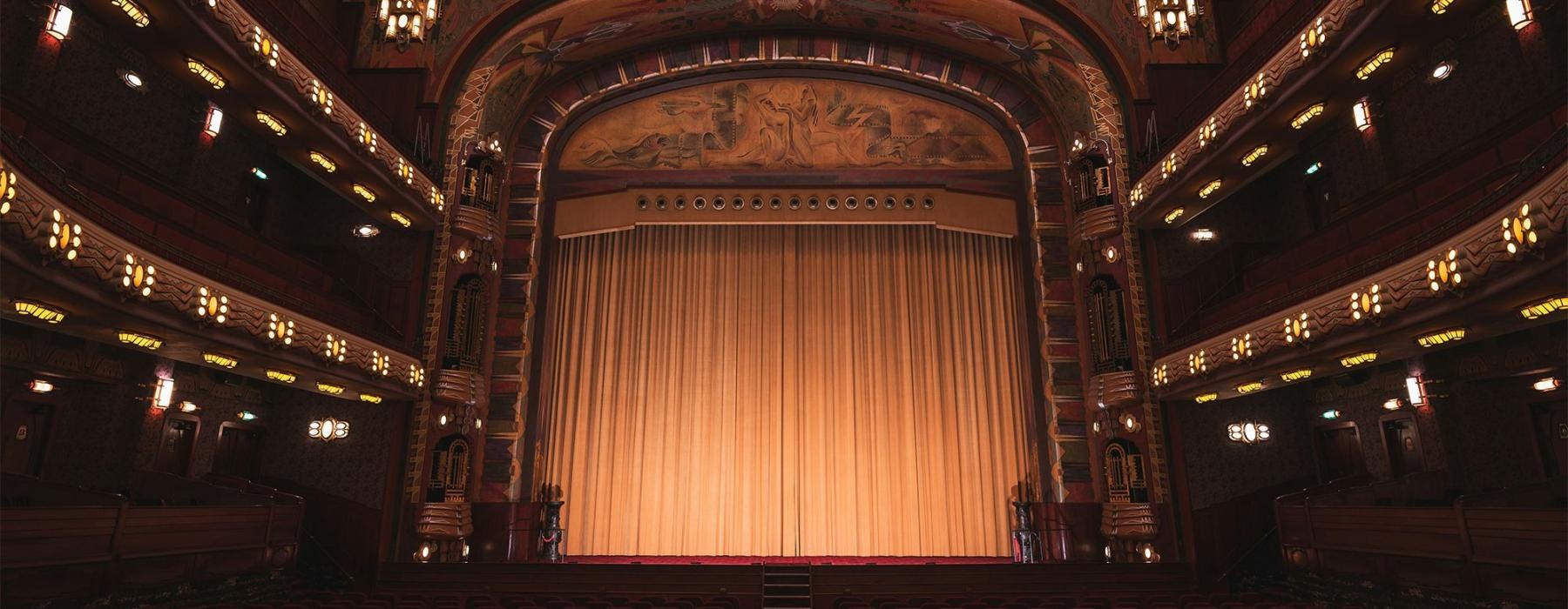 a theater with a stage and chairs